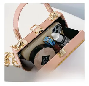Detail of pink crossbody bag interior showing storage space for phone and cosmetics