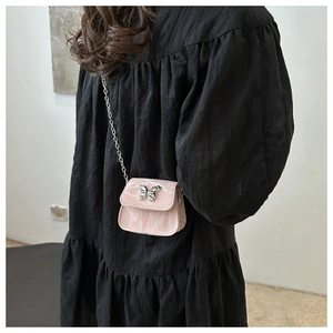 Pink patent leather mini crossbody bag with silver butterfly charm and chain strap