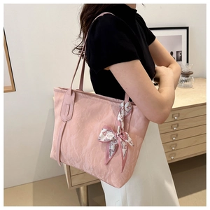 Detail of pink tote bag featuring cloud pleated texture and decorative silk scarf