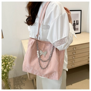 Pink pleated tote bag with silver chain, butterfly pendant and pearl details