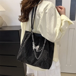 Large black pleated tote bag with silver chain and pearl charms for daily commute