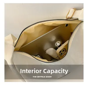 Detail of cream shoulder bag interior with spacious storage for tablet and makeup