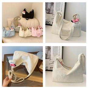 Detail showing colorful textured leather shoulder bags with cute plush charms
