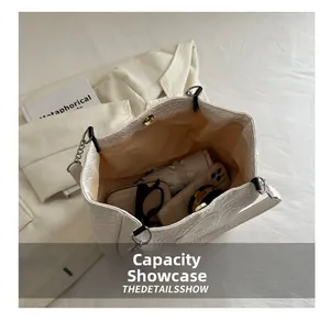 Capacity display of white woven tote bag showing internal storage for daily essentials
