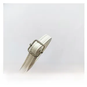 Detail of adjustable white leather shoulder strap with silver buckle and fine stitching
