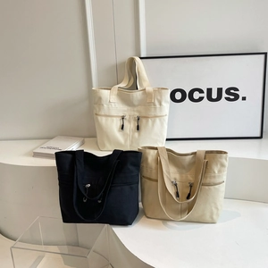 Minimalist canvas tote bags with double zipper pockets in cream, black, and khaki colors