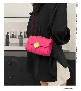 Quilted crossbody bag in rose red leather with a large golden buckle and chain strap
