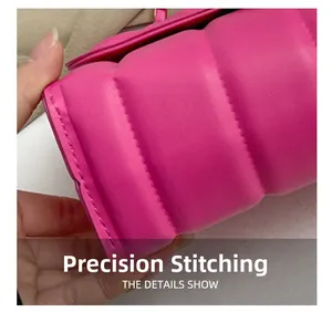 Macro detail of precision stitching on rose pink quilted leather chain handbag