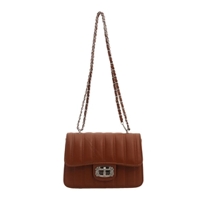 Brown quilted crossbody bag with vertical stitching and silver chain strap on white background