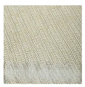 Close-up of beige woven tote bag showing detailed herringbone straw texture and pattern