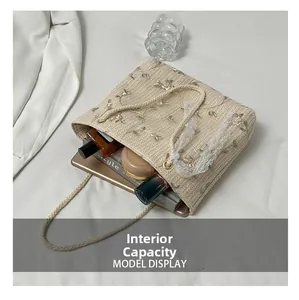 Internal capacity of the straw woven tote bag showing space for tablet and perfume