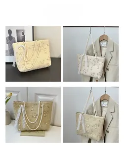 Detail of straw tote bag with floral embroidery and white lace ribbon decoration