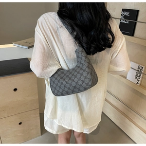 Detail of grey vintage geometric pattern on a stylish crescent shoulder bag for women