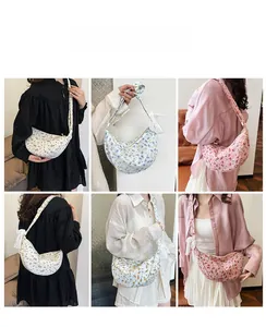 Close-up of floral canvas crescent bag with lace bow decoration and detailed fabric texture