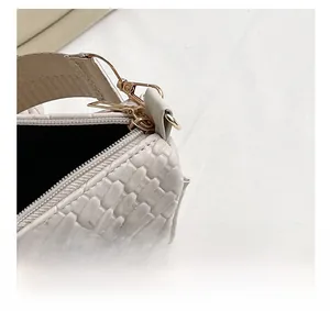 Détail macro de la texture tressée crème avec fermeture éclair en métal doré de qualité