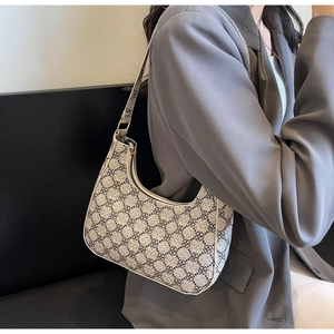 Detail view of the vintage crescent hobo bag featuring floral print and gold zipper