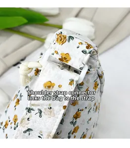 Detail of floral shoulder bag with white plastic strap connector and drawstring design
