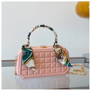 Detailed view of pink plaid quilted handbag with silk scarf handle and gold chain strap