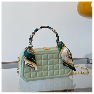 Detail of mint green box bag with quilted texture and vintage floral scarf handle wrap
