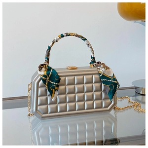 Silver quilted evening bag with silk scarf handle and gold chain strap detail