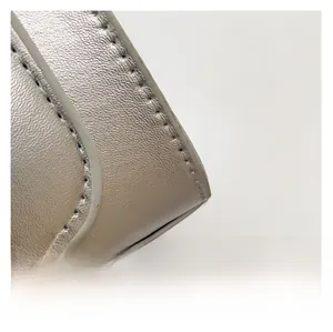 Close-up of premium silver grey leather texture with neat stitching and smooth edges