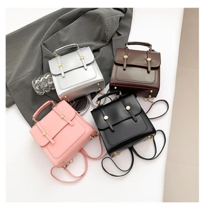 Flat lay of four minimalist PU leather backpacks in silver, brown, pink and black