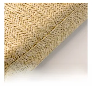Macro detail of beige woven texture and precise stitching on the minimalist straw bag