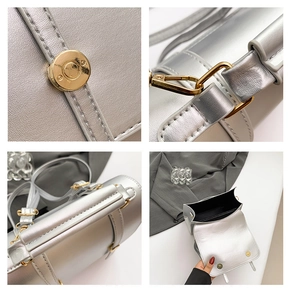 Detail of silver metallic PU leather bag showing golden hardware and precise stitching