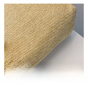 Close-up of natural straw material showing the intricate herringbone weave pattern