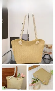 Detail of khaki straw tote bag with woven herringbone pattern and cotton rope handle