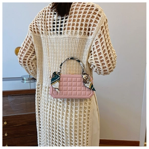 Pink waffle texture handbag with vintage scarf handle and chain strap on model