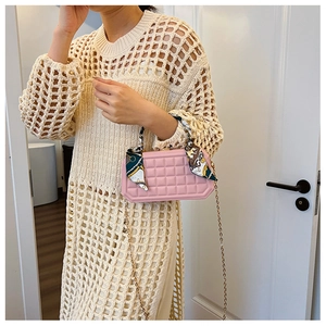 Pink checkered box handbag with floral scarf handle and gold chain strap on model