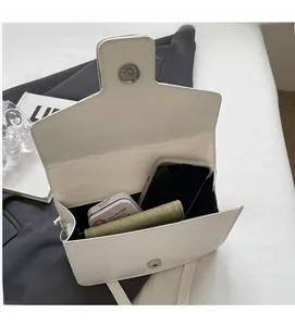 Top view of white leather crossbody bag interior showing spacious storage for essentials