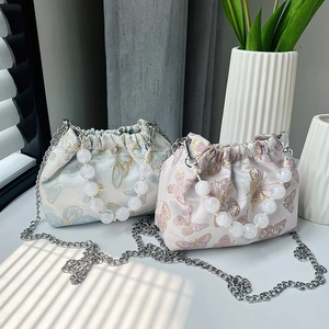 Elegant butterfly embroidered satin bucket bag with pearl handle and metal chain strap