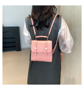 Pink mini leather backpack for women shown from the back perspective on a model