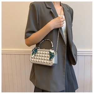 Detail of silver plaid box bag with silk scarf handle and golden chain shoulder strap