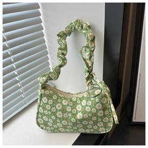 Détail d'un sac à bandoulière floral avec anse froncée et motifs de petites marguerites