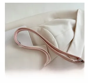Close-up of pink tote bag strap with silver metal ring and premium stitching details
