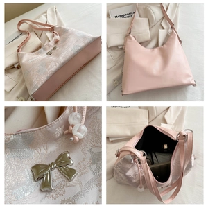 Detail view of pink tote bag with floral jacquard fabric and silver bow accent