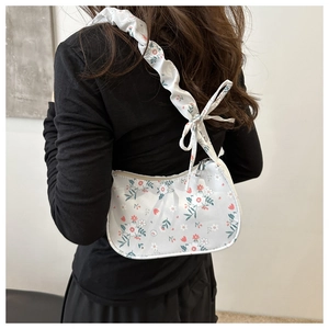 Floral hobo bag detail with ruched shoulder strap and delicate bow knot decoration
