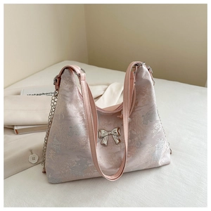 Detail of light pink silk tote with garden embroidery and silver butterfly buckle