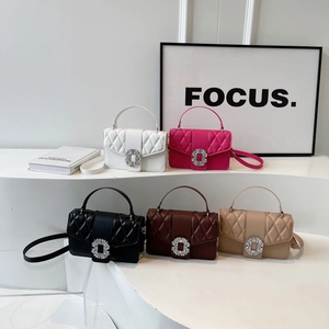 Quilted leather crossbody bags with rhinestone buckles in five colors on white steps