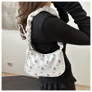 Detailed shot of white floral fabric hobo bag with Beautiful lettering print and pleated strap