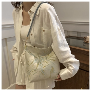 Detail of elegant Chinese style tote bag with bamboo leaf print and golden metal buckle