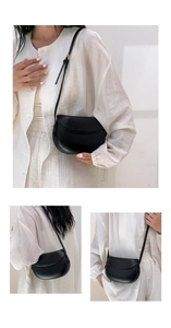 Detailed views of a minimalist black crescent shoulder bag with smooth matte finish