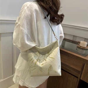 Elegant off-white shoulder bag with golden embroidery of bamboo leaves and birds