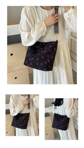 Detail of strawberry corduroy tote bag with ethnic patterned wide shoulder strap