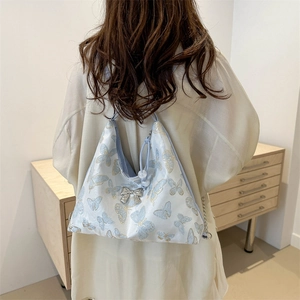 Blue Hobo tote bag with butterfly print and silver bow charm for women's daily wear