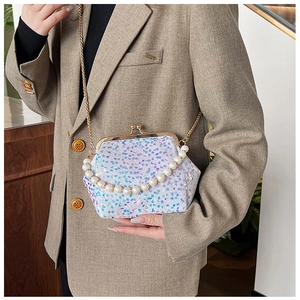 Close-up of sequined evening bag with iridescent finish and pearl handle chain
