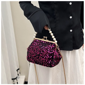 Detail of rose pink sequin clutch bag with pearl handle and golden chain strap